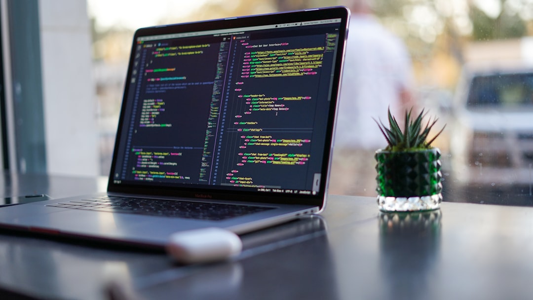 why-choose-us Laptop with code and plant in coffee shop